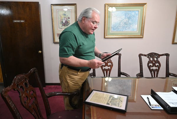 Bobby Hancock-Harris, funeral director, shows newspaper clips from President Carter’s mother Lillian Carter’s funeral at Hancock Funeral Home, Tuesday, Feb. 27, 2023, in Americus, GA. The funeral home served Carter’s family. (Hyosub Shin / Hyosub.Shin@ajc.com)