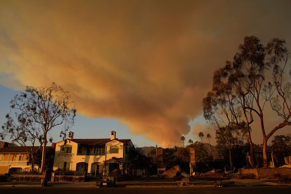 A plume of smoke rises from the Palisades Fire on Friday, Jan. 10, 2025, in the Pacific Palisades section of Los Angeles. (AP Photo/John Locher)