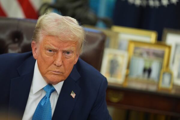 President Donald Trump speaks to reporters as he signs executive orders in the Oval Office of the White House, Friday, Jan. 31, 2025, in Washington. (AP Photo/Evan Vucci)