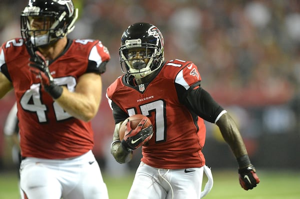 September 18, 2014 Atlanta - Atlanta Falcons wide receiver Devin Hester (17) runs for a touchdown against the Tampa Bay Buccaneers as Atlanta Falcons fullback Patrick DiMarco (42) clears his way in the first half during the first half in their NFL football game on Thursday, September 18, 2014. HYOSUB SHIN / HSHIN@AJC.COM