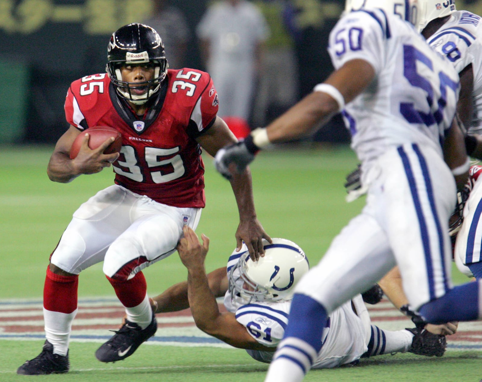 Falcons running back Jason Wright (left) is tackled by Indianapolis defensive end Josh Mallard during the American Bowl exhibition game Saturday, Aug. 6, 2005, at Tokyo Dome. Wright was waived by the Falcons before the season.