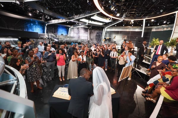 Destinee and Anthony Baker still got to cut their wedding cake after Hurricane Dorian forced them to cancel their wedding plans in Charleston. They got married at work, Turner Studios in Atlanta, instead on Friday, September 6, 2019. (D'Marcus Pulse/Turner Studios/contributed photo to AJC)