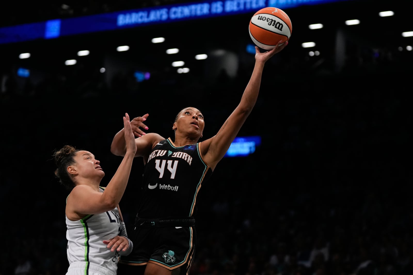 New York Liberty forward Betnijah Laney-Hamilton (44) puts up a shot against Minnesota Lynx guard Kayla McBride (21) during the first quarter of Game 5 of the WNBA basketball final series, Sunday, Oct. 20, 2024, in New York. (AP Photo/Pamela Smith)