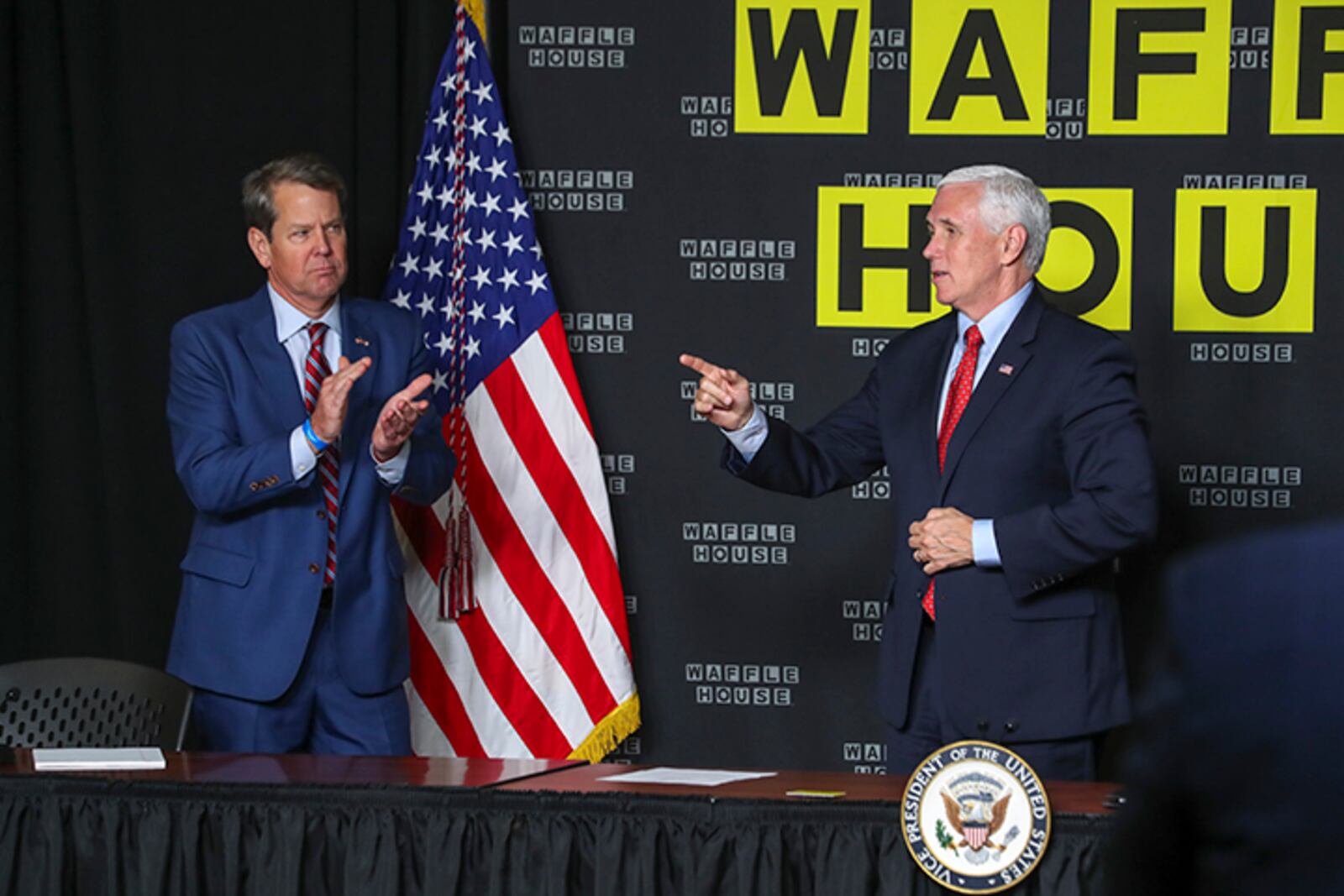 Gov. Brian Kemp (left) applauds Vice President Mike Pence after his remarks at the roundtable discussion at the Waffle House corporate offices in Norcross on Friday, May 22, 2020. (Photo: JOHN SPINK/JSPINK@AJC.COM)