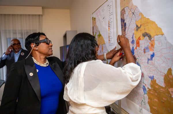 Lorraine Cochran-Johnson watches as volunteer Arzina Chand, right, fills in the map as the campaign manager calls precincts results for the election of the DeKalb County CEO Tuesday, June 18, 2024.  Cochran-Johnson, the first African American women elected to the position, celebrates with her supporters at Hotel Spice & Sky Atlanta Perimeter in Chamblee.  (Jenni Girtman for The Atlanta Journal-Constitution)