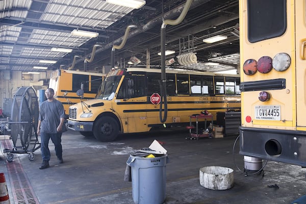 Mechanics work on Atlanta Public School busses at the Atlanta Public Schools Transportation hub in Atlanta’s Sylvan Hills community, Friday, May 31, 2019. (Alyssa Pointer/alyssa.pointer@ajc.com)