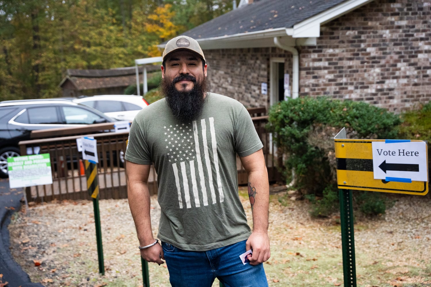 Guillermo Martinez wears an American flag t-shirt outside of a poll site on election day in Lithonia, Georgia, Tuesday, Nov. 5, 2024. (Olivia Bowdoin for the AJC). 