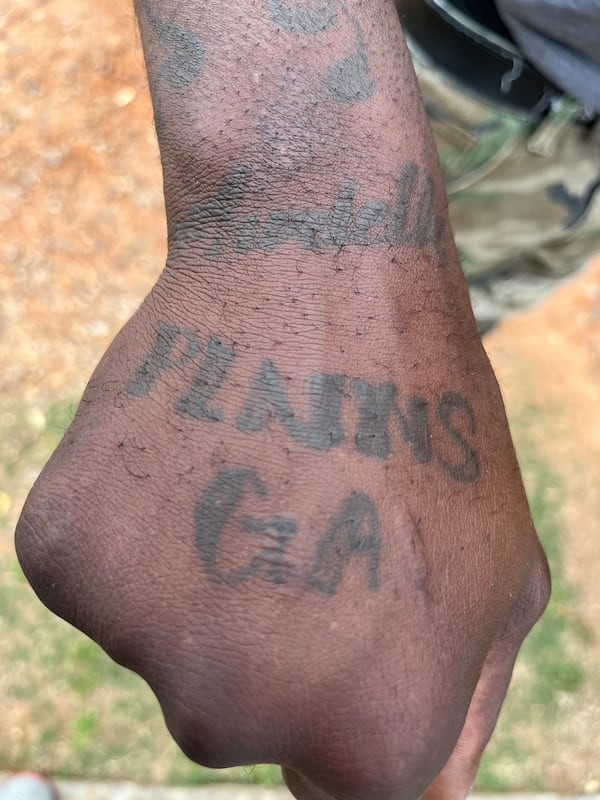 Montavius Bridges, on Feb. 24, 2023,  shows a tattoo he has highlighting his hometown of Plains, where former U.S. president Jimmy Carter was from. Matt Kempner / AJC