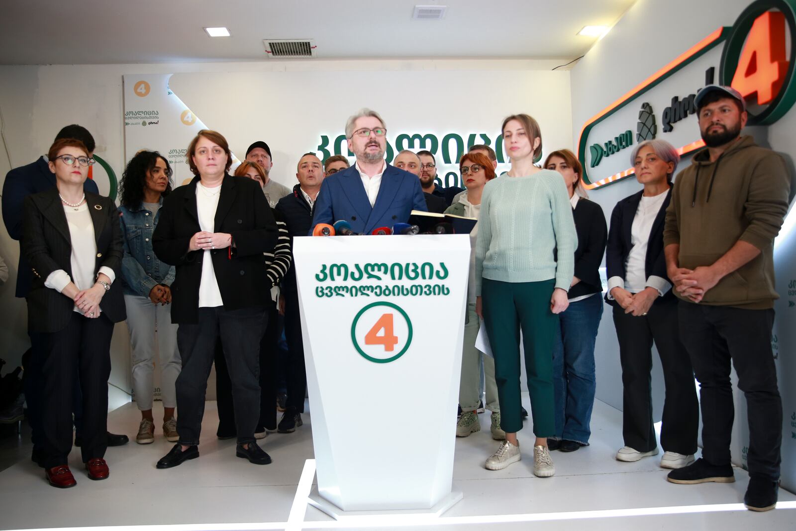 Nika Gvaramia, leader of Coalition for Changes, center, speaks to the media at coalition's headquarters after the parliamentary election in Tbilisi, Georgia, Sunday, Oct. 27, 2024. (AP Photo/Zurab Tsertsvadze)