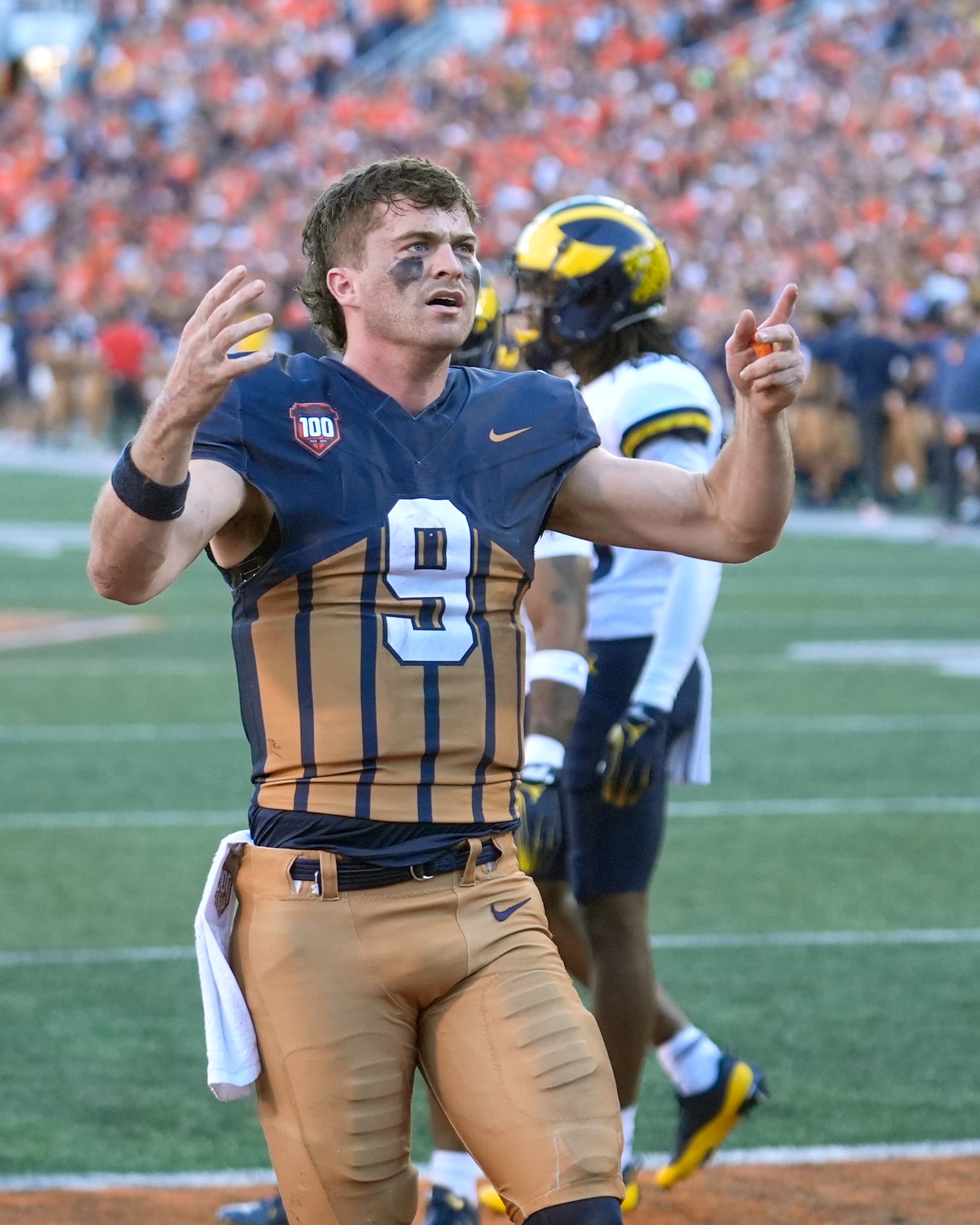 Illinois quarterback Luke Altmyer celebrates his touchdown during the second half of an NCAA college football game against Michigan on Saturday, Oct. 19, 2024, in Champaign, Ill. (AP Photo/Charles Rex Arbogast)