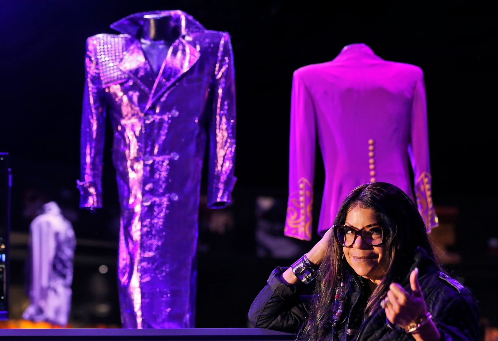 FILE - Tyka Nelson, sister of the late musician Prince, appears in front of his costumes at the "My Name is Prince" exhibition at the O2 Arena in London, on Oct. 26, 2017. (AP Photo/Frank Augstein, File)