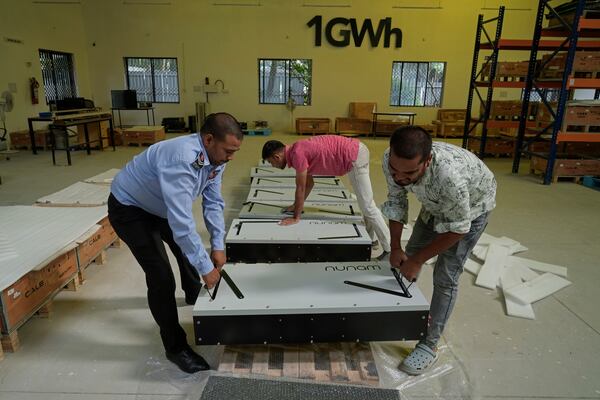 Employees of Nunam pack refurbished battery packs, made from used electric vehicle batteries, before shipping to their clients, at their facility in Bengaluru, India, Tuesday, Oct. 8, 2024. (AP Photo/Aijaz Rahi)