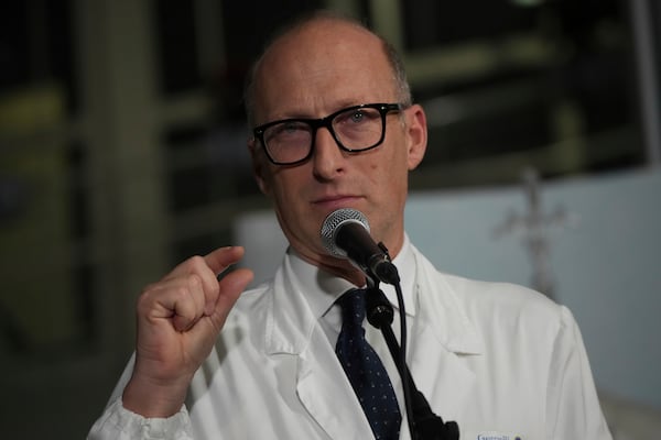 Surgeon Sergio Alfieri speaks to journalists, Friday, Feb. 21, 2025, in the entrance hall of Rome's Agostino Gemelli Polyclinic where Pope Francis is being treated for pneumonia. (AP Photo/Alessandra Tarantino)