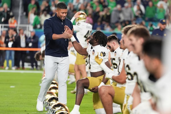 Notre Dame head coach Marcus Freeman greets players before the Orange Bowl NCAA College Football Playoff semifinal game against Penn State on Thursday, Jan. 9, 2025, in Miami Gardens, Fla. (Rebecca Blackwell/AP)