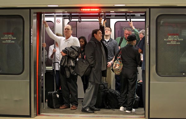 Passengers board an automated people mover on the way to their airplane connection in the transportation mall at Hartsfield-Jackson Atlanta International Airport Tuesday morning in Atlanta. JASON GETZ / JGETZ@AJC.COM