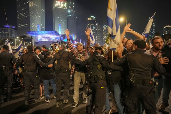 Israeli police try to push back protesters from a main road after Prime Minister Benjamin Netanyahu has dismissed his defense minister Yoav Gallant in a surprise announcement in Tel Aviv, Israel, Tuesday, Nov. 5, 2024. (AP Photo/Oded Balilty)