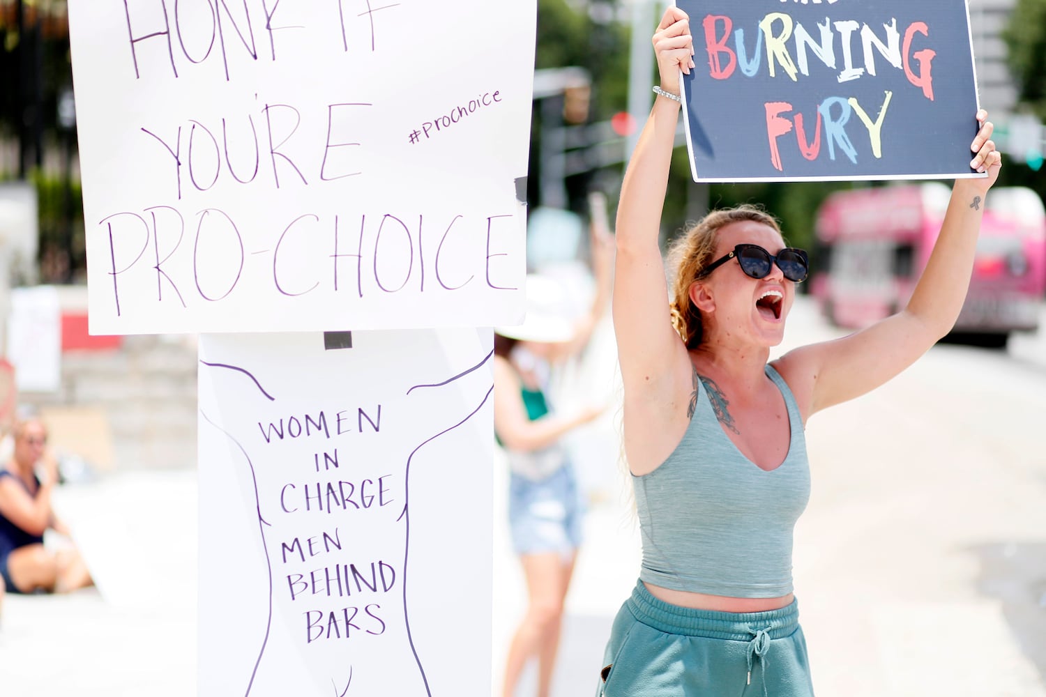 Sarah G. reacts as a car honk outside the Georgia State Capitol, where abortion rights activists rally to protest the  U.S. Supreme Court's overturning of Roe v Wade. Sunday, June 26, 2022. Miguel Martinez /miguel.martinezjimenez@ajc.com