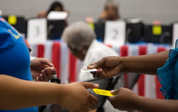 A woman receives her "I'm a Georgia Voter" sticker after casting her vote during Saturday early voting at the C.T. Martin Natatorium and Recreation Center in Atlanta, Georgia, on Saturday. The last day of early voting for the May 22 primary is Friday, May 18. (REANN HUBER/REANN.HUBER@AJC.COM)