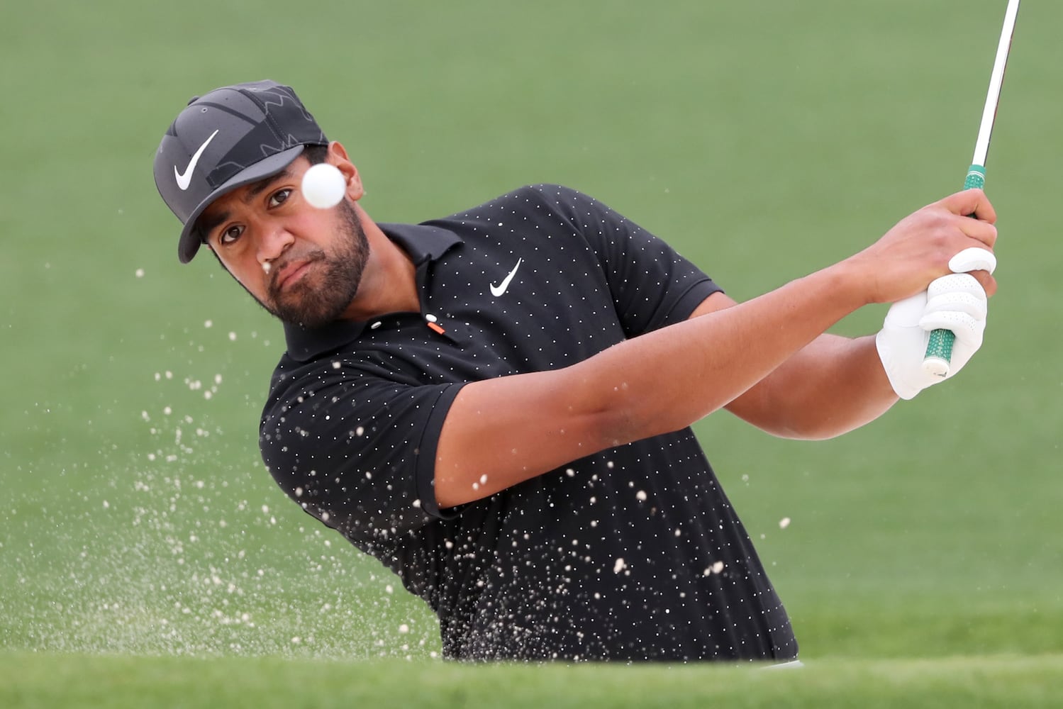 April 10, 2021, Augusta: Tony Finau hits out of the bunker on the second hole during the third round of the Masters at Augusta National Golf Club on Saturday, April 10, 2021, in Augusta. Curtis Compton/ccompton@ajc.com