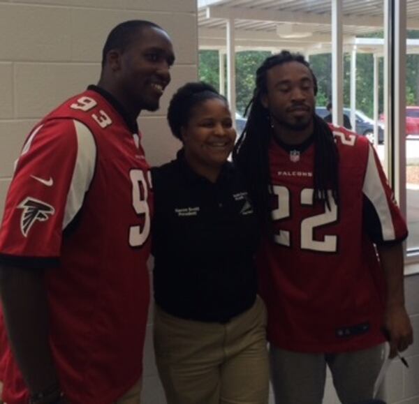 Falcons Malliciah Goodman and Dezmen Southward posing with Nacoe Scott, president of Youth 4 Change in Hampton, Ga. (D. Orlando Ledbetter/Dledbetter@ajc.com)