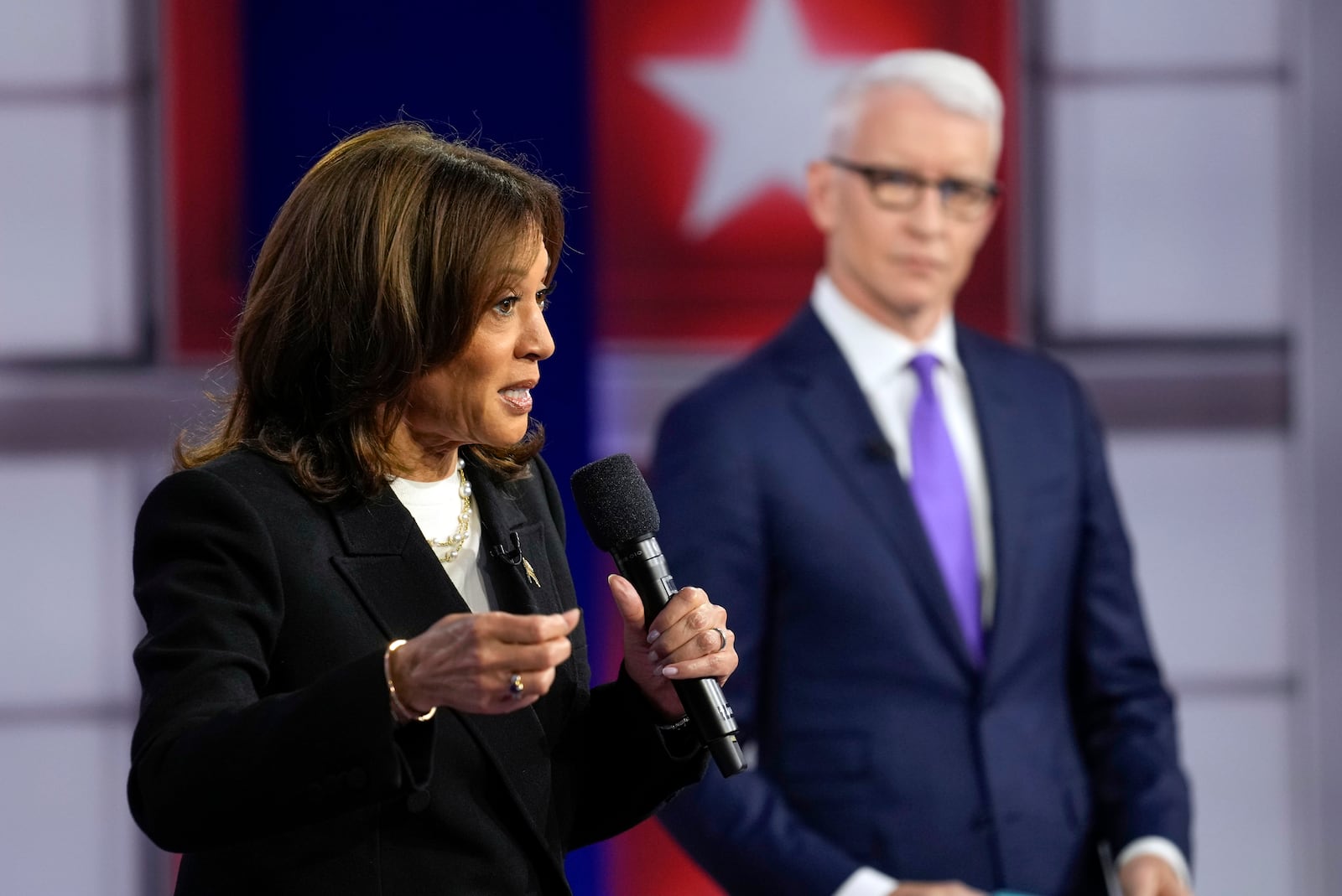 Democratic presidential nominee Vice President Kamala Harris speaks during a CNN town hall in Aston, Pa., Wednesday, Oct. 23, 2024, as moderator Anderson Cooper listens. (AP Photo/Matt Rourke)