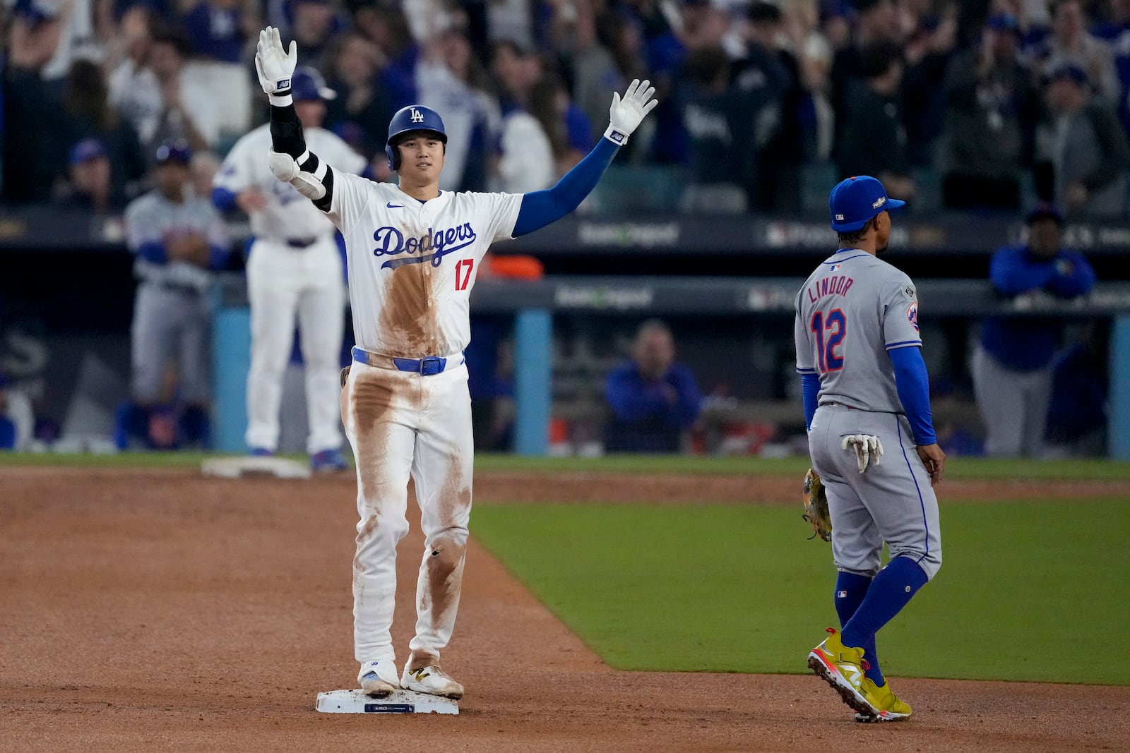 Los Angeles Dodgers' Shohei Ohtani celebrates after his RBI double against the New York Mets during the fourth inning in Game 1 of a baseball NL Championship Series, Sunday, Oct. 13, 2024, in Los Angeles. (AP Photo/Mark J. Terrill)