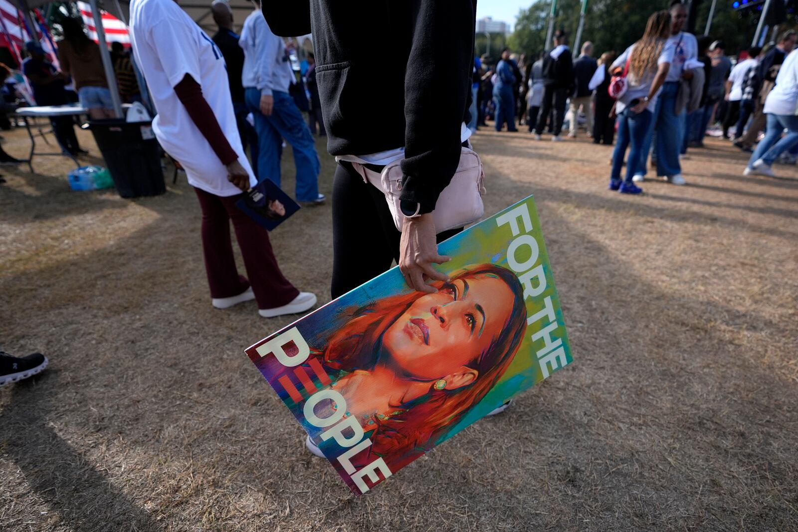 A supporter holds a sign for Democratic presidential nominee Vice President Kamala Harris at a campaign rally outside the Atlanta Civic Center, Saturday, Nov. 2, 2024. (AP Photo/Brynn Anderson)