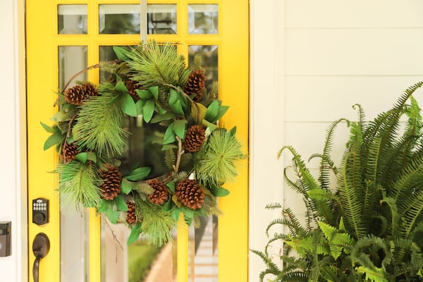 Wreaths are not just for Christmas. Adding pine cones to a wreath can give it a rustic look. Reynolds Rogers/FOR THE AJC