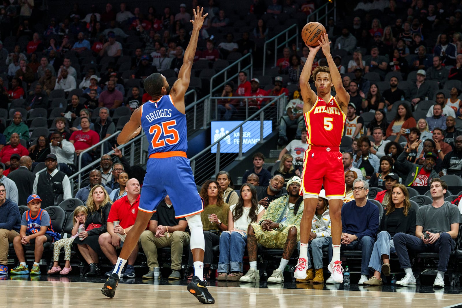 Atlanta Hawks guard Dyson Daniels (5) shoots a three pointer while guarded by New York Knicks forward Mikal Bridges (25) during the first half of an NBA basketball game, Wednesday, Nov. 6, 2024, in Atlanta. (AP Photo/Jason Allen)