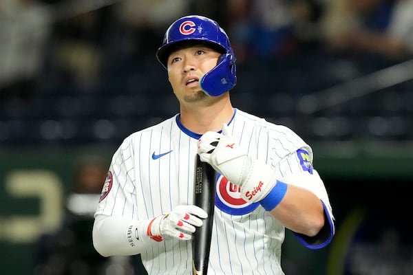 Chicago Cubs' Seiya Suzuki bats against the Hanshin Tigers during the fourth inning of a spring training baseball game in Tokyo, Saturday, March 15, 2025. (AP Photo/Eugene Hoshiko)