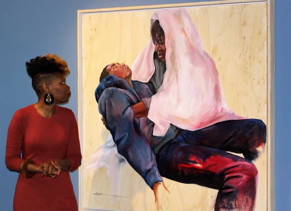 Shanequa Gay stands next to her painting "La Pieta," after its unveiling at the Oglethorpe University Museum of Art.