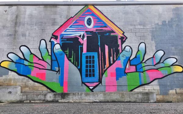 PLF (Mayson Baptist Church in Midtown): The lawsuit says that this mural on Mayson Street NE "precariously positions a home in a set of outstretched hands."