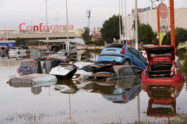 Cars are seen half submerged after floods in Valencia, Spain, Friday, Nov. 1, 2024. (AP Photo/Alberto Saiz)