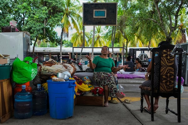 Women rest inside a temporary shelter at the Suyapa neighborhood, partially flooded by the Ulúa River's overflow after Tropical Storm Sara, in Potrerillos, Honduras, Sunday, Nov. 17, 2024. (AP Photo/Moises Castillo)