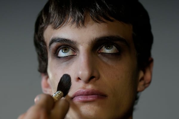 Model Antoine gets made up by a make up artist in the backstage prior a Marni Fall/Winter 2025-2026 Womenswear fashion show, during the Fashion Week, in Milan, Italy, Wednesday, Feb. 26, 2025. (AP Photo/Luca Bruno)