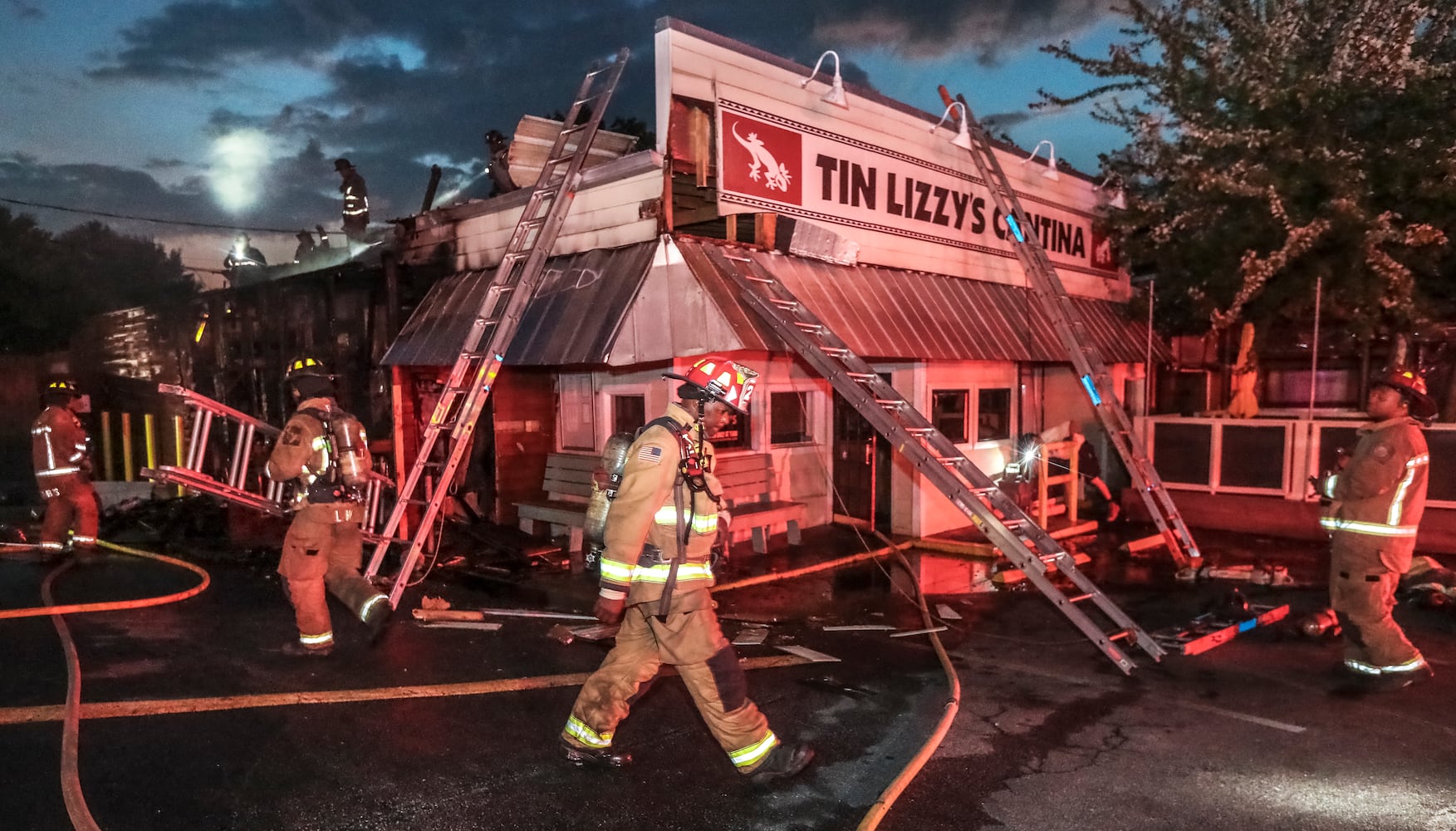 Fire broke out at the Buckhead Tin Lizzy’s Cantina on Tuesday morning, Sept. 20, 2022, sending huge flames shooting high above the roofline. The restaurant was empty when it ignited. According to Atlanta fire Battalion Chief Quincey Watts, “There was some interior damage, but most of the damage is on the exterior side.”  One firefighter suffered exhaustion, but Watts said there were no major injuries. (John Spink / John.Spink@ajc.com)

