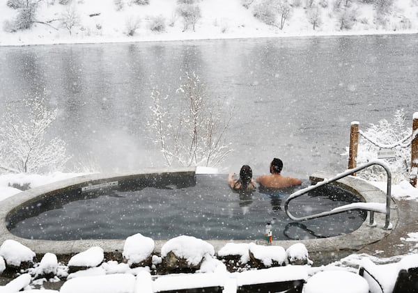 A couple looks out on the Colorado River as they relax in a pool at Iron Mountain Hot Springs in Glenwood Springs, Colorado, on Jan. 28, 2023. (RJ Sangosti/The Denver Post/TNS)