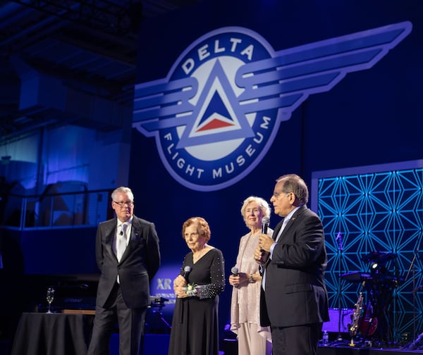 Delta Air Lines celebrations its 100-year anniversary on Saturday, March 15, 2025, at the Delta Flight Museum. James Sarvis, far right, is the vice president of global clean and field stations for Delta, and he addressed the crowd at the gala.  (Jenni Girtman for The Atlanta Journal-Constitution)