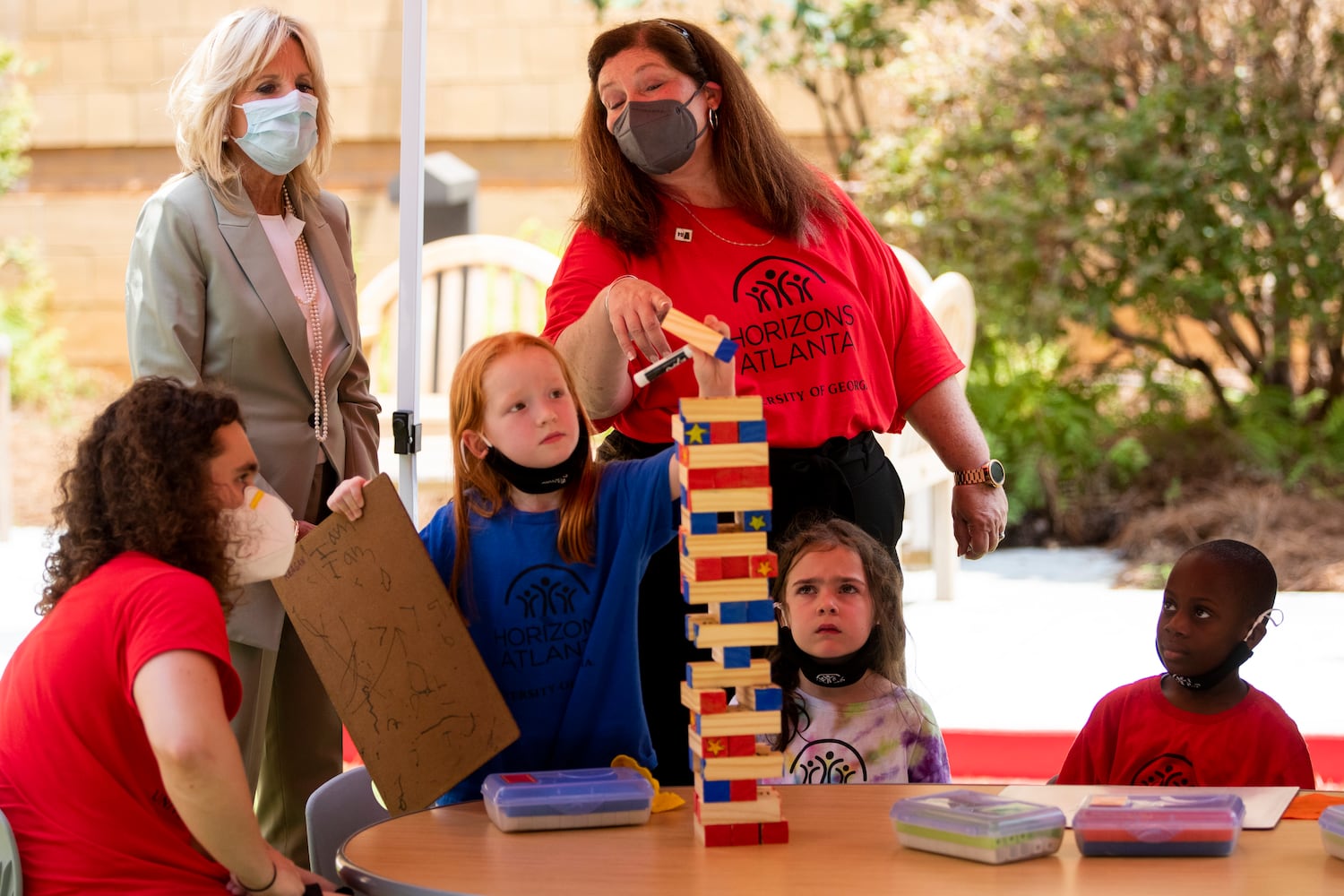 First Lady Jill Biden speaks with Susan Cardin, the Horizons Atlanta program director, as first-grade students show an example of a math lesson using Jenga blocks while Biden visits a Horizons Atlanta summer learning program at the University of Georgia in Athens, Georgia on Thursday, July 21, 2022. The program serves students from Barnett Shoals Elementary School. (Chris Day/Christopher.Day@ajc.com)