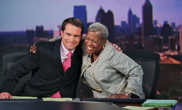 Channel 2 Action News co-anchor John Bachman hugs Monica Pearson on her final day at work in July 2012. 
John Spink, jspink@ajc.com