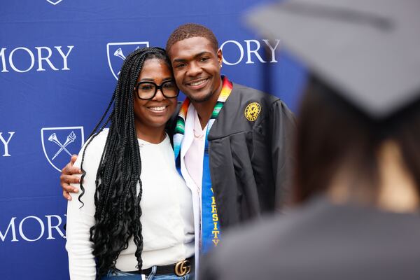 Julius Pugh gets a photo taken with his aunt Tawanna Butler during Emory University's 179th Commencement ceremony at Gas South Arena on Monday, May 13, 2024, in Duluth. 
(Miguel Martinez / AJC)