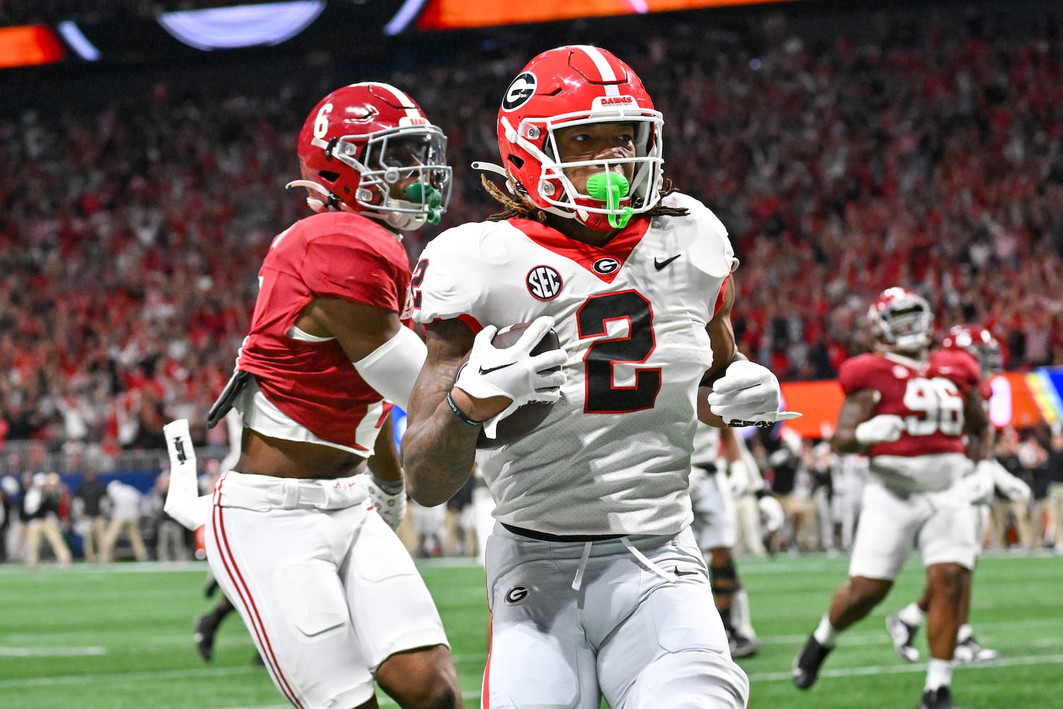 Georgia Bulldogs running back Kendall Milton (2) runs for a 17 yard touchdown against the Alabama Crimson Tide during the first half of the SEC Championship football game at the Mercedes-Benz Stadium in Atlanta, on Saturday, December 2, 2023. (Hyosub Shin / Hyosub.Shin@ajc.com)