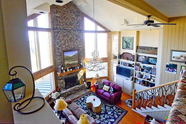 The antler chandelier was already in the home when John and Andrea Pruitt bought it in 2004, but they installed a rough-hewn cedar mantle and refinished the built-in bookcases.