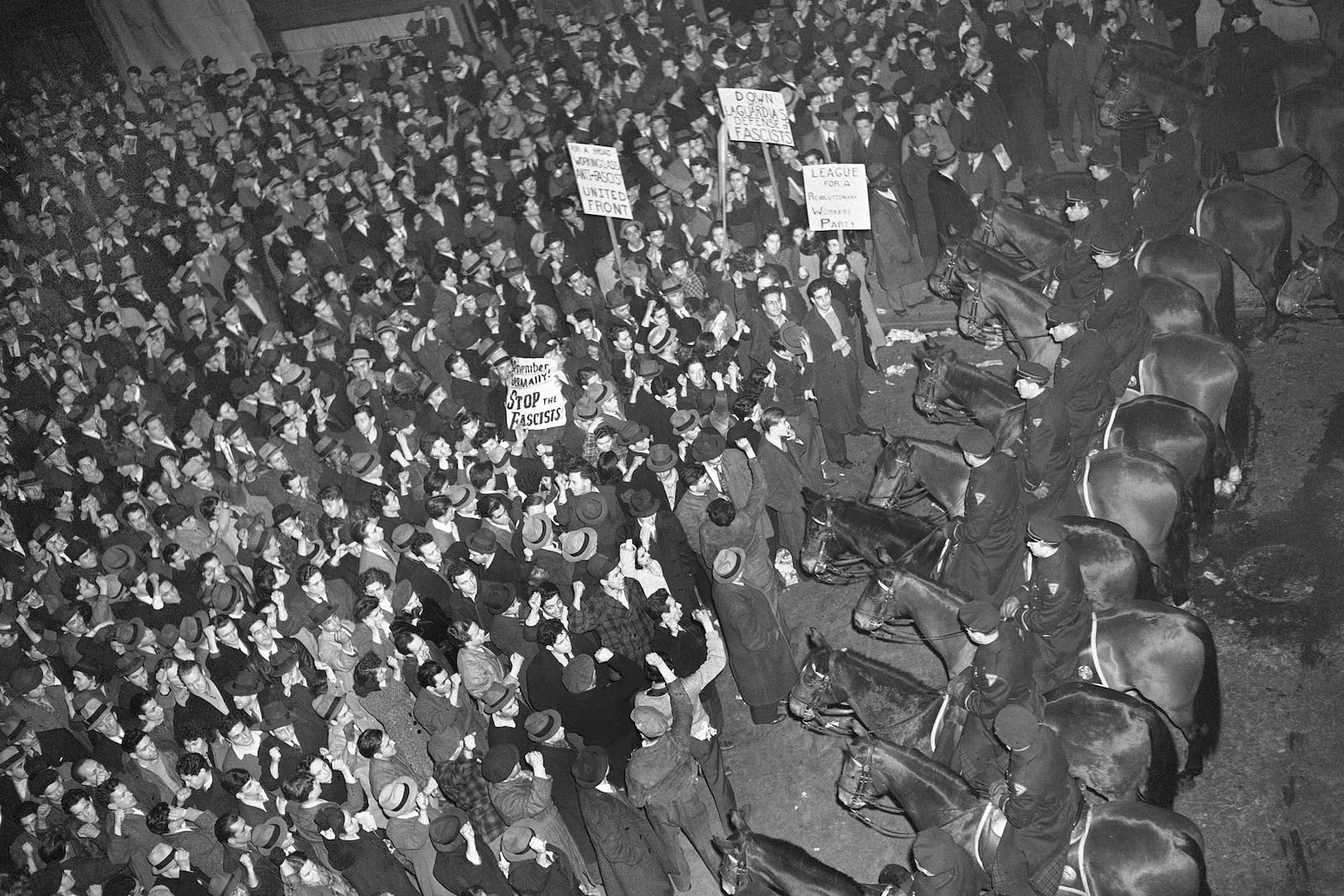 FILE - In this Feb. 20, 1939 file photo, New York City's mounted police form a line outside Madison Square Garden to hold in check a crowd that packed the streets where the German American Bund was holding a rally. (AP Photo/Murray Becker, File)