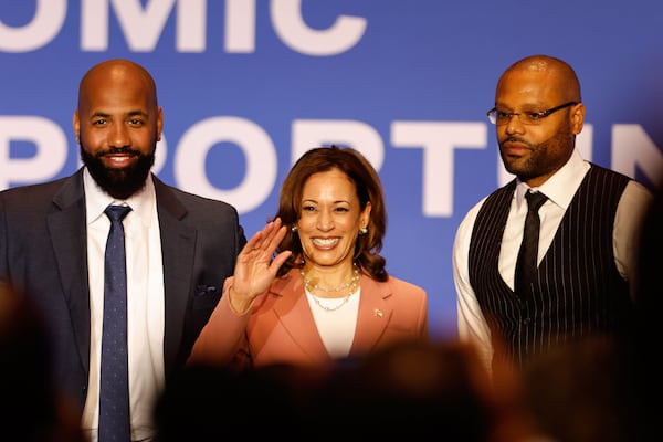 Podcast creators Troy Millings (left) and Rashad Bilal (right) pose for a photo with Vice President Kamala Harris (center) during an April event in Georgia focused on improving economic opportunities for Black men.