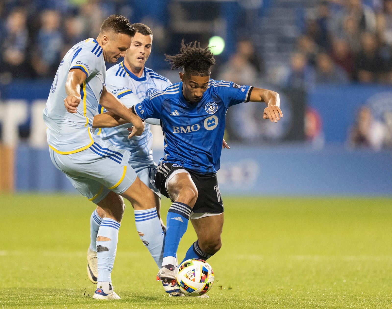 CF Montreal midfielder Nathan Saliba, right, is challenged by Atlanta United defender Stian Gregersen, left, during the first half of an MLS playoff soccer game in Montreal, Tuesday, Oct. 22, 2024. (Christinne Muschi/The Canadian Press via AP)