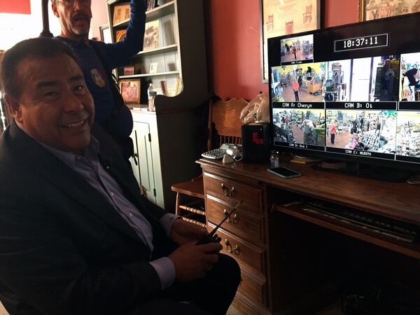 John Quinones watches the monitors as customers intermingle with actors at the toy store next door. CREDIT: Rodney Ho/ rho@ajc.com