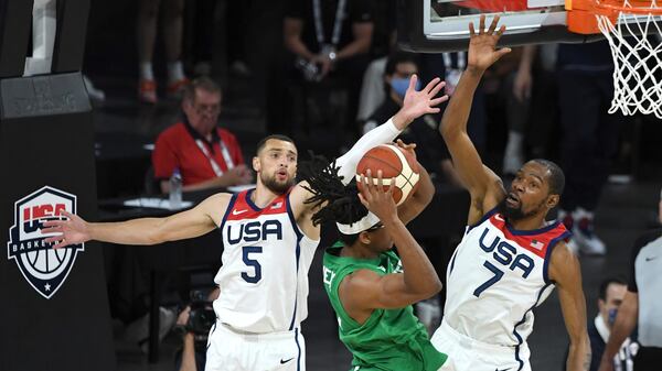 United States' Zach LaVine (5) and Kevin Durant (7) defend against Nigeria's Chima Moneke during an exhibition game Saturday, July 10, 2021, in Las Vegas. (David Becker/AP)