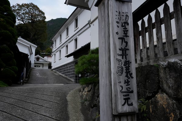 A sign for the brewery of "Sawanoi," a Japanese sake brand, is seen at the entrance of Ozawa Sake Brewery in Ome, on the western outskirts of Tokyo, Japan, Wednesday, Nov. 13, 2024. (AP Photo/Hiro Komae)