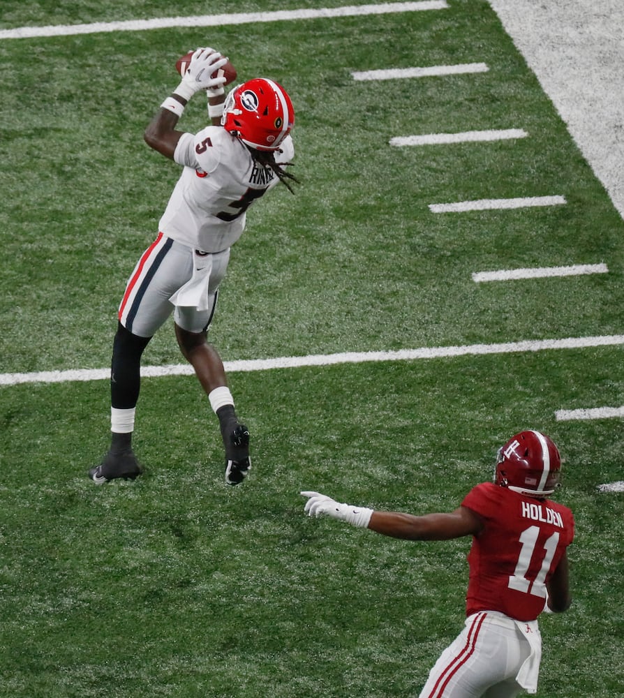 1/10/22 - Indianapolis -  Georgia Bulldogs defensive back Kelee Ringo (5) intercepts a pass intended for  Alabama Crimson Tide wide receiver Traeshon Holden (11) and returns it for a TD in the fourth quarter at the 2022 College Football Playoff National Championship  between the Georgia Bulldogs and the Alabama Crimson Tide at Lucas Oil Stadium in Indianapolis on Monday, January 10, 2022.   Bob Andres / robert.andres@ajc.com